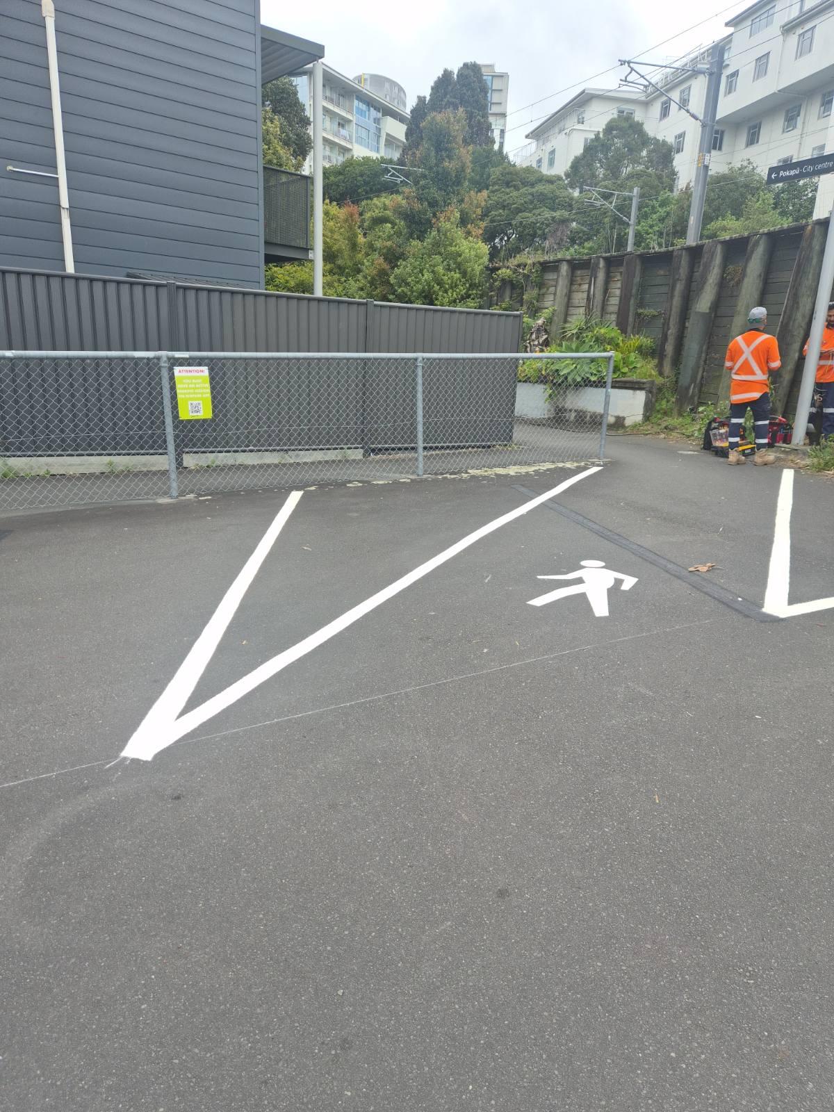 Completed line marking showing parking bays and directional arrows